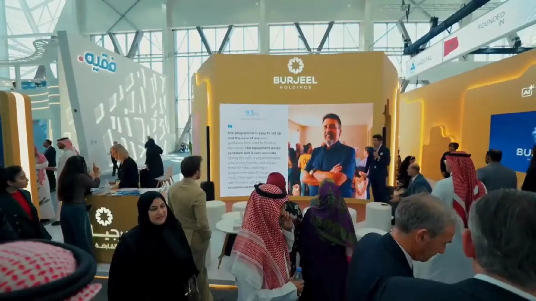 Attendees walk past the Burjeel Holdings booth built by Rayqube.